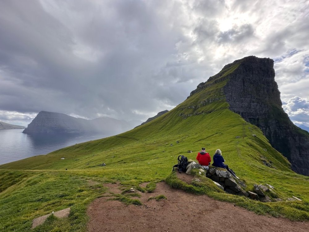 Tourists enjoy a view on Kalsoy Island at the Faroe Islands, Sept. 4, 2025. (AP Photo/Cara Anna)