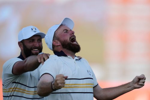 Europe's Shane Lowry celebrates with Jon Rahm after making the winning putt on the 18th hole during their singles match on the Bethpage Black golf course at the Ryder Cup golf tournament, Sunday, Sept. 28, 2025, in Farmingdale, N.Y. (AP Photo/Seth Wenig)