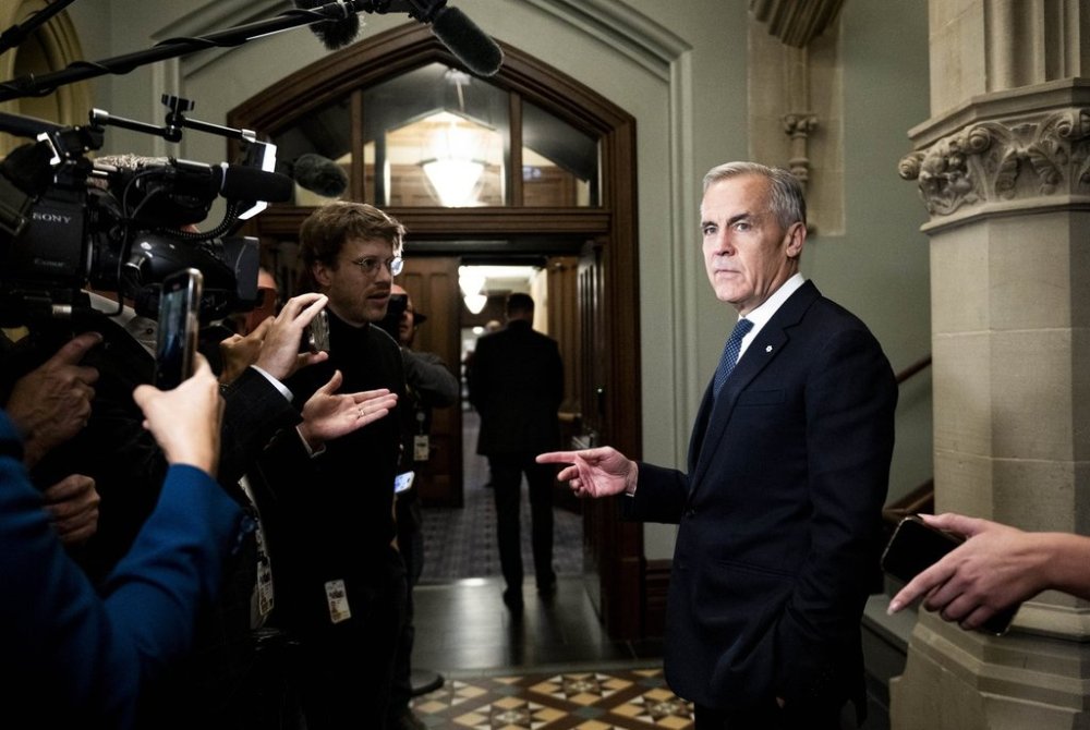 Prime Minister Mark Carney waits to speak to reporters ahead of a cabinet meeting on Parliament Hill in Ottawa, on Tuesday, Oct. 21, 2025. THE CANADIAN PRESS/Spencer Colby