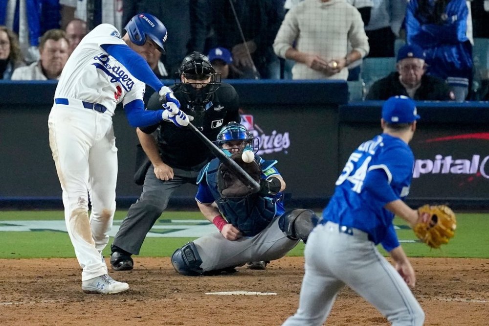 Los Angeles Dodgers' Freddie Freeman connects for a grand slam home run off Toronto Blue Jays' pitcher Brendon Little (54) during the 18th inning in Game 3 of baseball's World Series, Monday, Oct. 27, 2025, in Los Angeles. (AP Photo/David J. Phillip)
