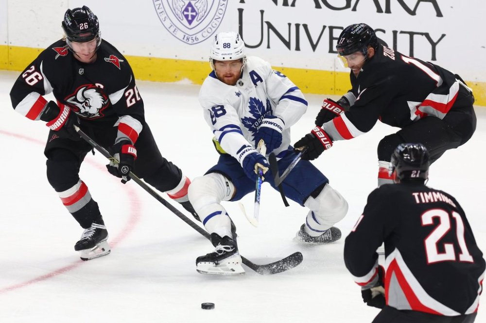 Toronto Maple Leafs right wing William Nylander (88) skates between Buffalo Sabres defenceman Rasmus Dahlin (26) and left wing Jason Zucker (17) during the third period of an NHL hockey game Friday, Oct. 24, 2025, in Buffalo, N.Y. (AP Photo/Jeffrey T. Barnes)