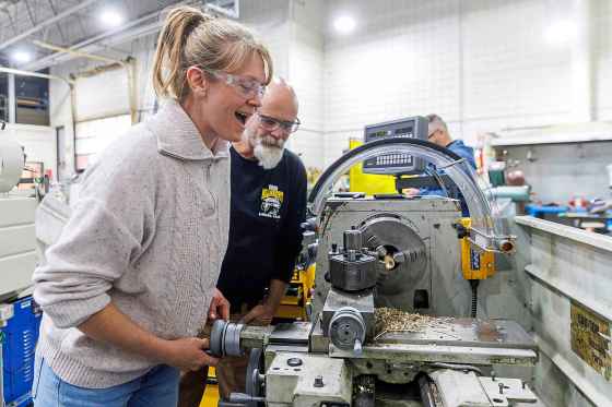 Samantha Law makes a brass ring on a lathe while being supervised by industrial mechanic/millwright instructor Mike Williams at the Manitoba Institute of Trades and Technology LauncHER into Trades event Wednesday. (Mike Deal / Free Press)