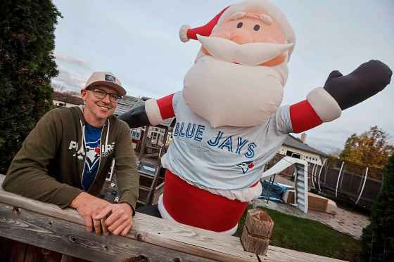Jay Porath’s 14-foot Santa in St. Vital has donned the colours of the Toronto Blue Jays as they fight to bring Canada its first World Series since 1993. (John Woods / Free Press)