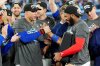 Blue Jays designated hitter George Springer and teammate Vladimir Guerrero Jr. celebrate after defeating the Seattle Mariners 4-3 in Game 7 of the MLB American League Championship Series in Toronto on Oct. 20, 2025. THE CANADIAN PRESS/Frank Gunn