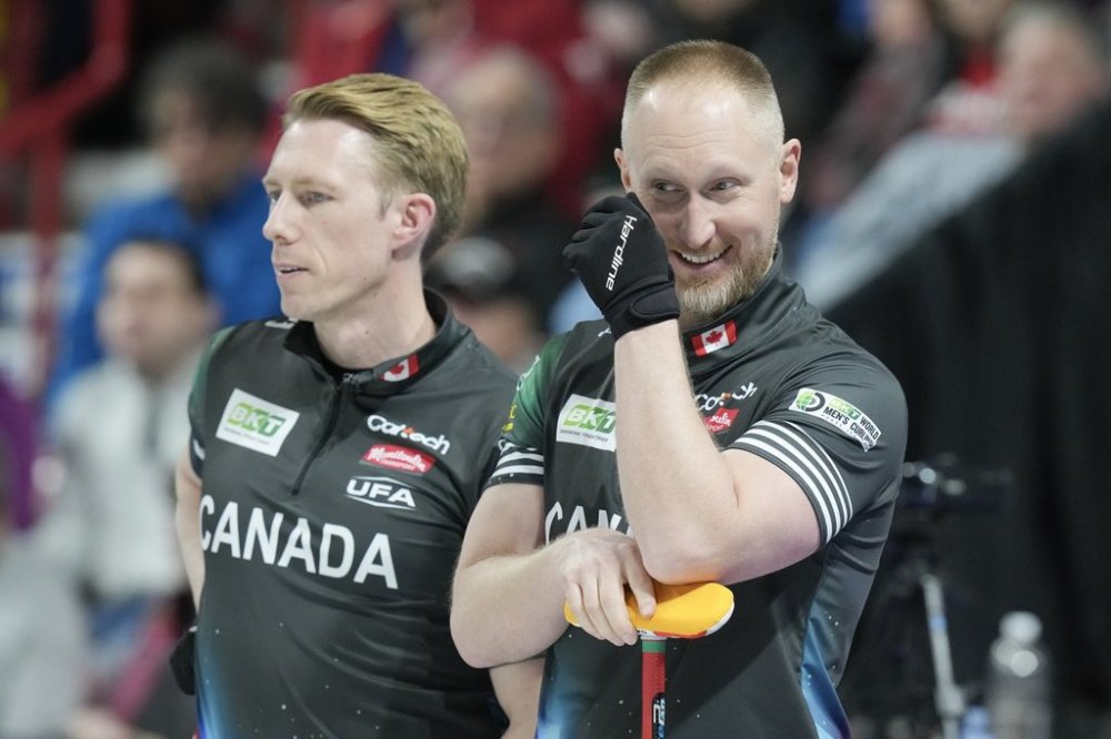 Canada's skip Brad Jacobs (right) and Marc Kennedy react during their semifinal match against Scotland at the World Men's Curling Championship in Moose Jaw, Sask. on Saturday April 5, 2025. THE CANADIAN PRESS/Chris Young