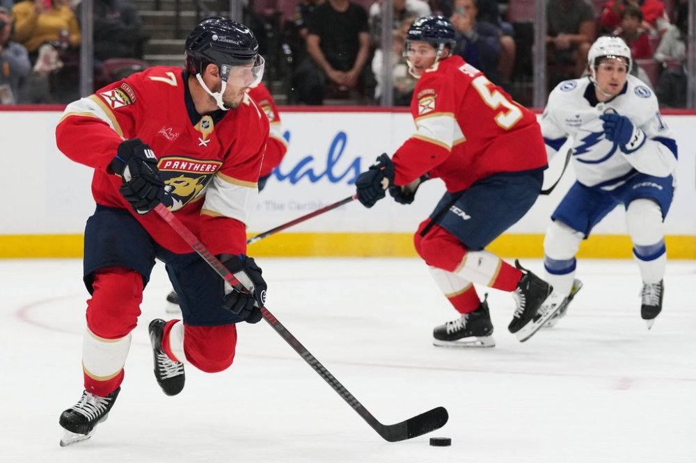 Florida Panthers defenseman Dmitry Kulikov (7) skates with the puck during the first period of an NHL hockey preseason game against the Tampa Bay Lightning, Saturday, Oct. 4, 2025, in Sunrise, Fla. (AP Photo/Lynne Sladky)