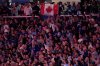 Fans wave the Canadian flag during the national anthem prior to Game 2 of baseball's World Series between the Los Angeles Dodgers and the Toronto Blue Jays, Saturday, Oct. 25, 2025, in Toronto. (AP Photo/David J. Phillip)