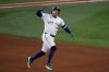 Toronto Blue Jays' George Springer celebrates his three run home run against the Seattle Mariners during the seventh inning in Game 7 of baseball's American League Championship Series, Monday, Oct. 20, 2025, in Toronto. (AP Photo/David J. Phillip)