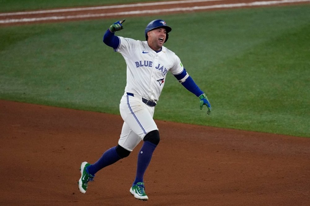 Toronto Blue Jays' George Springer celebrates his three run home run against the Seattle Mariners during the seventh inning in Game 7 of baseball's American League Championship Series, Monday, Oct. 20, 2025, in Toronto. (AP Photo/David J. Phillip)