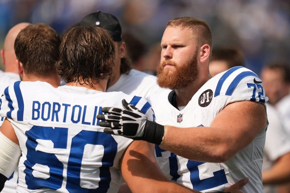 FILE - Indianapolis Colts offensive tackle Braden Smith, right, greets teammate center Tanor Bortolini before an NFL football game against the Los Angeles Chargers Sunday, Oct. 19, 2025, in Inglewood, Calif. (AP Photo/Gregory Bull,File)