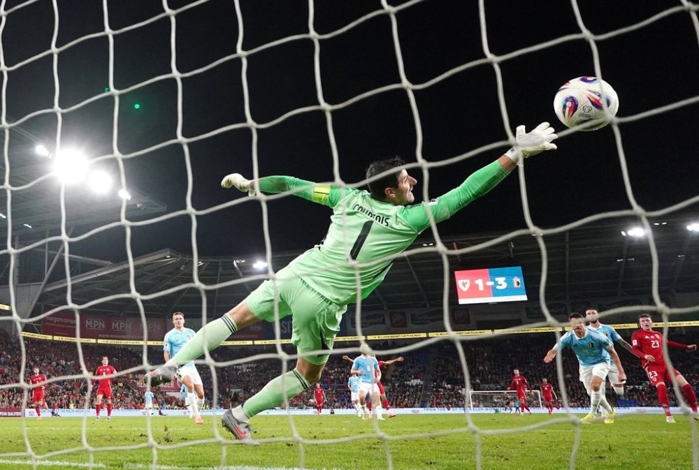 Belgium goalkeeper Thibaut Courtois can't stop a goal by Wales' Nathan Broadhead during the World Cup European Qualifying soccer match between Wales and Belgium at the Cardiff City Stadium in Cardiff, Monday, Oct. 13, 2025. (David Davies/PA via AP)