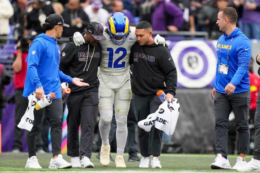 Trainers help Los Angeles Rams wide receiver Puka Nacua off the field during the first half of an NFL football game against the Baltimore Ravens Sunday, Oct. 12, 2025, in Baltimore. (AP Photo/Stephanie Scarbrough)
