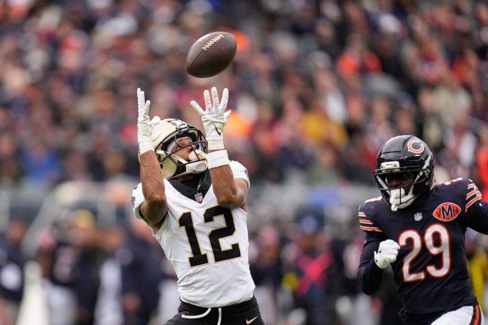 New Orleans Saints wide receiver Chris Olave (12) pulls in a long pass play past Chicago Bears cornerback Tyrique Stevenson (29) in the first half of an NFL football game, Sunday, Oct. 19, 2025, in Chicago. (AP Photo/Erin Hooley)