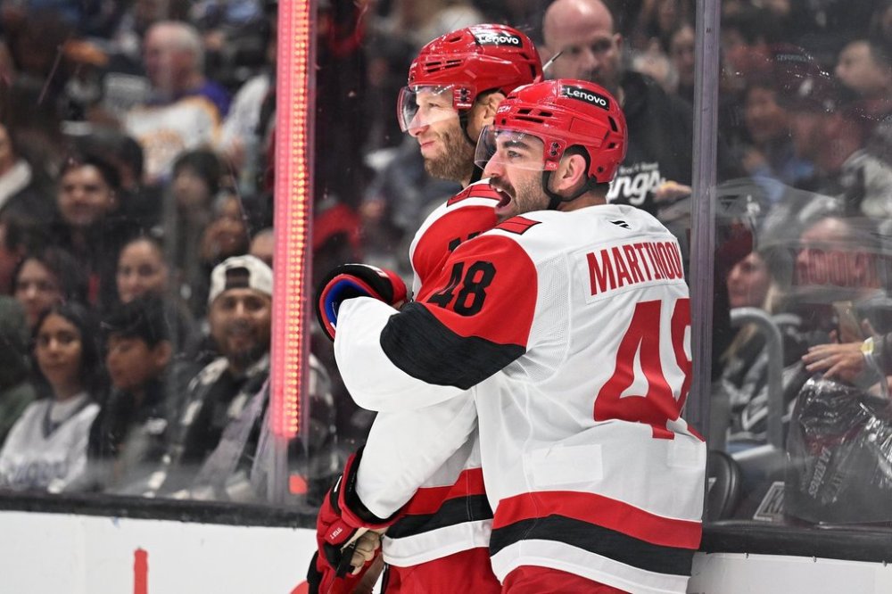 Carolina Hurricanes center Jordan Staal, left, celebrates with teammate Jordan Martinook (48) after scoring a goal during the first period of an NHL hockey game Saturday, October 18, 2025, in Los Angeles. (AP Photo/Wally Skalij)