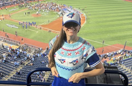 Karla Courtney is shown wearing the Toronto Blue Jays-themed sweater she's knitting during the playoff run as the Blue Jays celebrate their ALCS victory in Toronto in this Monday, Oct. 20, 2025 handout photo. THE CANADIAN PRESS/Handout - Karla Courtney (Mandatory Credit)