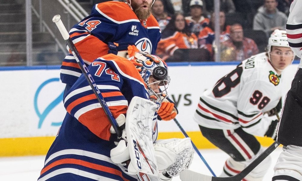 Chicago Blackhawks' Connor Bedard (98) looks back as Edmonton Oilers goalie Stuart Skinner (74) makes the save during first period NHL action, in Edmonton on Saturday, Nov. 1, 2025. THE CANADIAN PRESS/Jason Franson