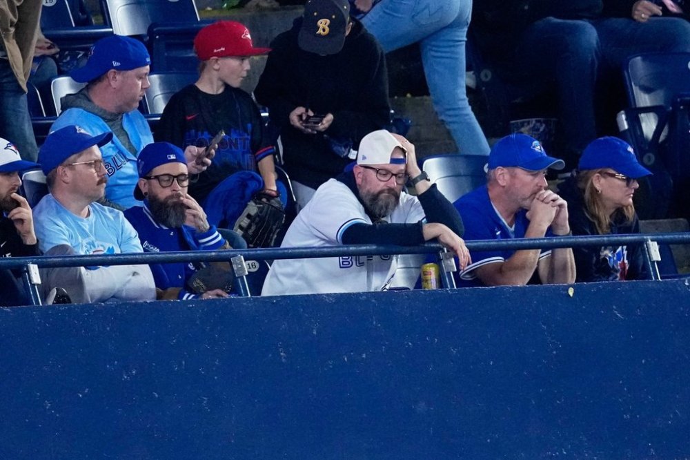 Toronto Blue Jays fans watch during the ninth inning in Game 2 of baseball's American League Championship Series against the Seattle Mariners, Monday, Oct. 13, 2025, in Toronto. (AP Photo/David J. Phillip)