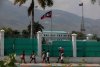 FILE - People walk past the National Palace in Port-au-Prince, Haiti, March 25, 2024. (AP Photo/Odelyn Joseph, File)