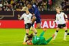 France's Marie-Antoinette Katoto jumps over Germany's goalkeeper Stina Johannesduring the UEFA Women's Nations League semifinal first leg soccer match between Germany and France in Duesseldorf, Germany, Friday, Oct. 24, 2025. (AP Photo/Martin Meissner)