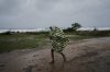 A man walks under the rain before the arrival of Hurricane Melissa in Canizo, a village in Santiago de Cuba, Tuesday, Oct. 28, 2025. (AP Photo/Ramón Espinosa)