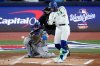 Toronto Blue Jays infielder Bo Bichette connects for a base hit against the Los Angeles Dodgers during the first inning in Game 1 of baseball's World Series on Oct. 24, 2025, in Toronto. (AP Photo/David J. Phillip)