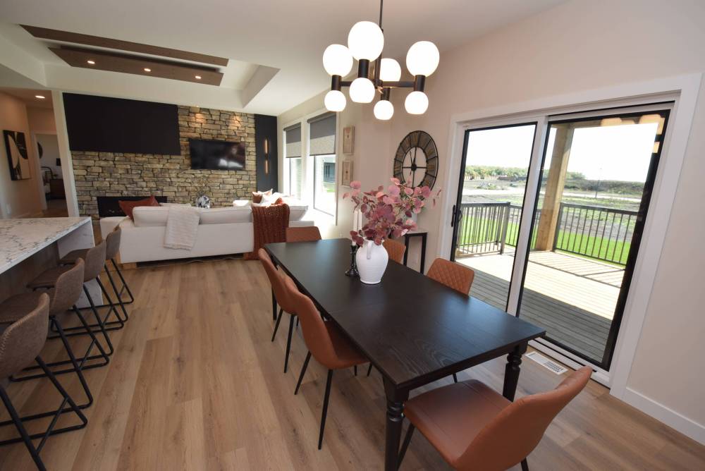 The spacious dining area has a countryside view while the great room is anchored by a gas fireplace set in a stone feature wall.