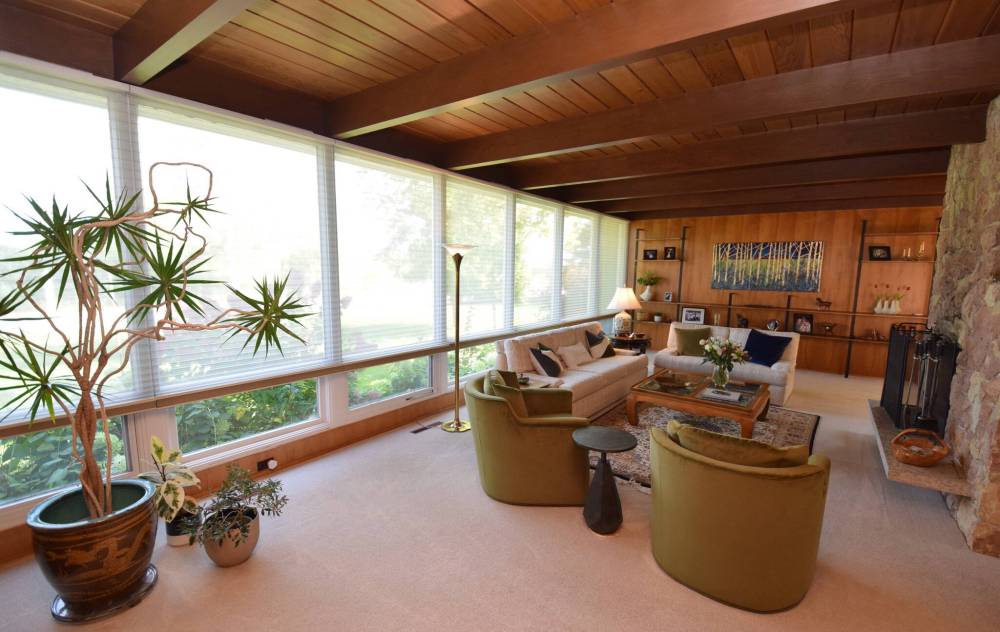 The beamed wood ceiling, wall of windows and stone fireplace make the living room at 71 D’Arcy Drive a quietly spectacular space.