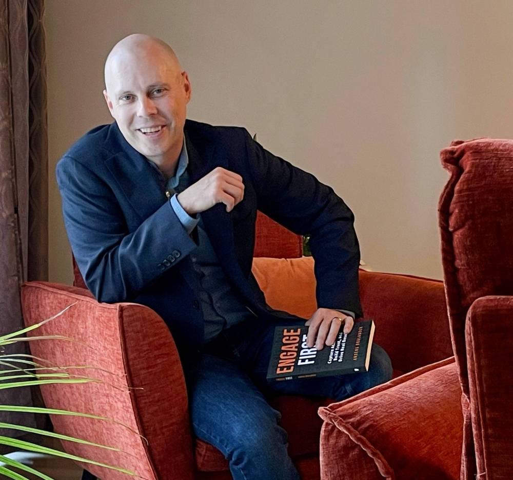 RUTH BONNEVILLE / FREE PRESS
Anders Boulanger with a copy of his new book on the fundamental skills of making personal connections, Engage First.