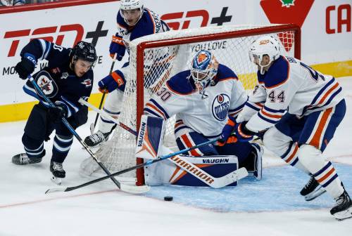 JOHN WOODS / FREE PRESS FILES
                                Winnipeg Jets’ Nikita Chibrikov (90) attempts a wraparound on Edmonton Oilers goaltender Calvin Pickard (30) as Joshua Brown (44) defends during second period pre-season NHL action in Winnipeg on Tuesday, September 23, 2025.