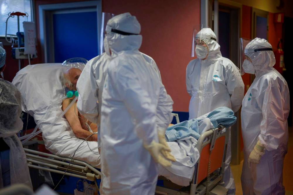 Domenico Stinellis / Associated Press files
In this 2020 photo, medical staff in Rome observe an elderly patient with COVID-19 in an intensive care unit.