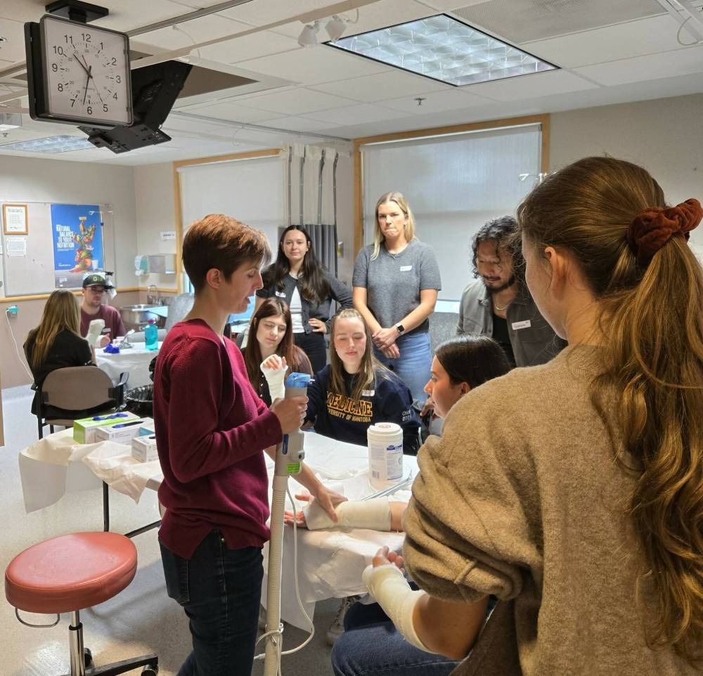 Dr. Leah Koetting (red sweater), a family physician at the Swan Valley Primary Care Centre, is seen explaining the proper casting procedures to first- and second-year medical students from the University of Manitoba’s Max Rady College of Medicine. The students are part of the student-led Rural Interest Group (RIG) program at U of M, which gives students an opportunity to see what a rural physician practice could look like. (Prairie Mountain Health)