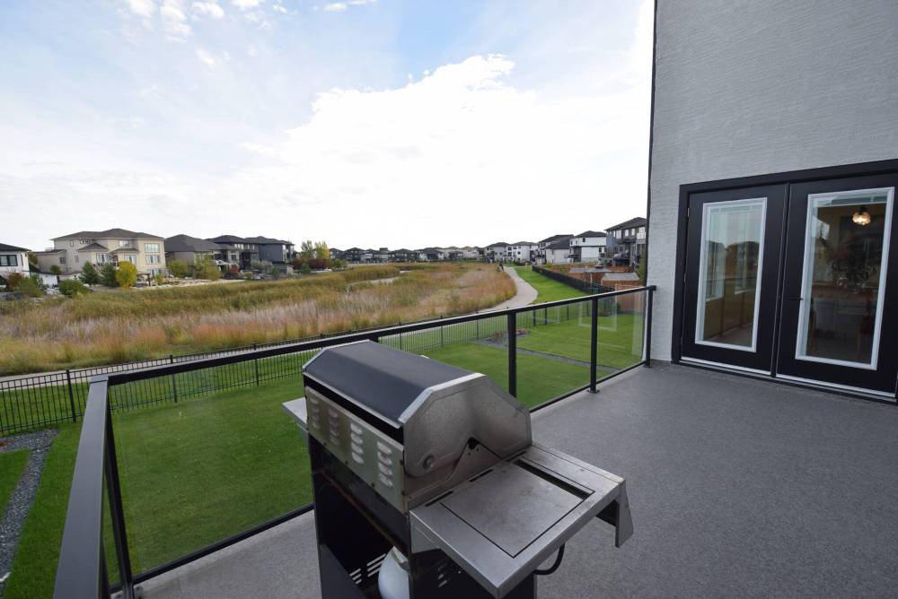 The back deck overlooks an immaculate yard and the lake just beyond.