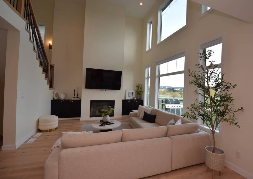 An 18-foot ceiling and a wall of windows make the room an impressive and relaxing space.