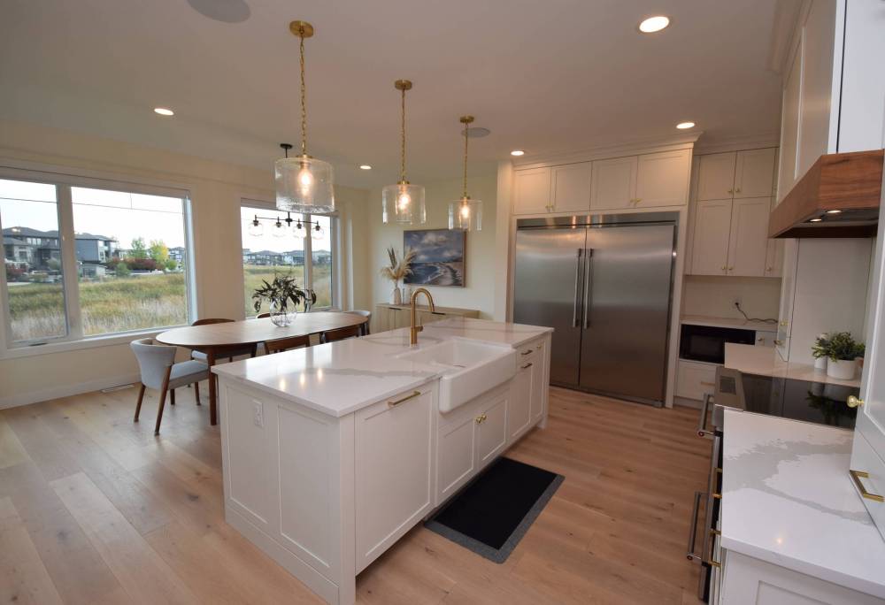 Todd Lewys photos / Free Press
The kitchen at 182 Willow Creek Road boasts a large island with quartz countertops and gleaming cabinetry, adjacent to a spacious dining area.