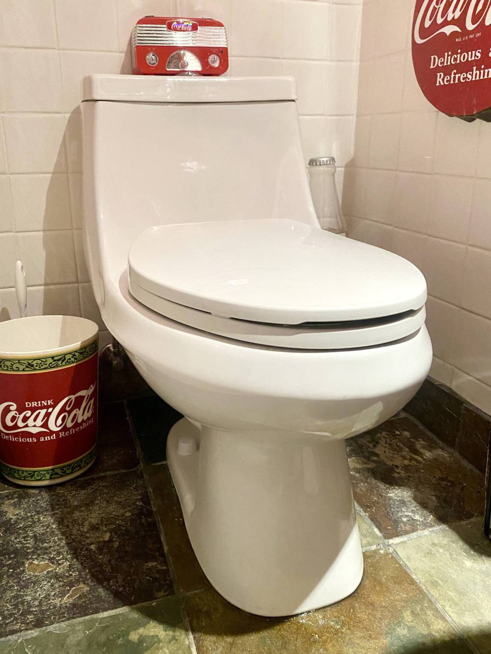 A sleek one-piece toilet now sits where the two-piece was.