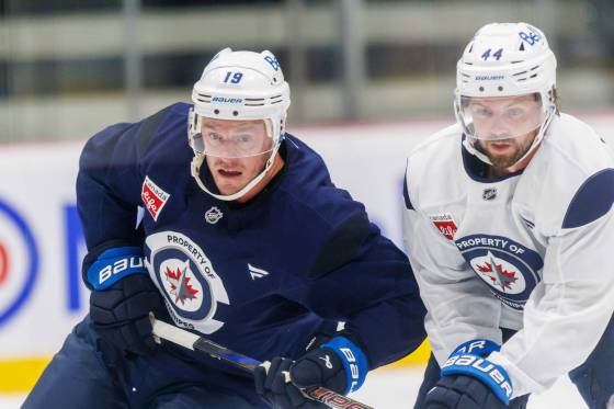 Winnipeg Jets forward Jonathan Toews (left) battles defenceman Josh Morrissey for the puck during training camp. (Mike Deal / Free Press files)