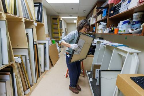 MIKE DEAL / FREE PRESS
                                Buhler Gallery curator hannah_g checks out some of the more than 400 artworks in storage at St. Boniface Hospital.