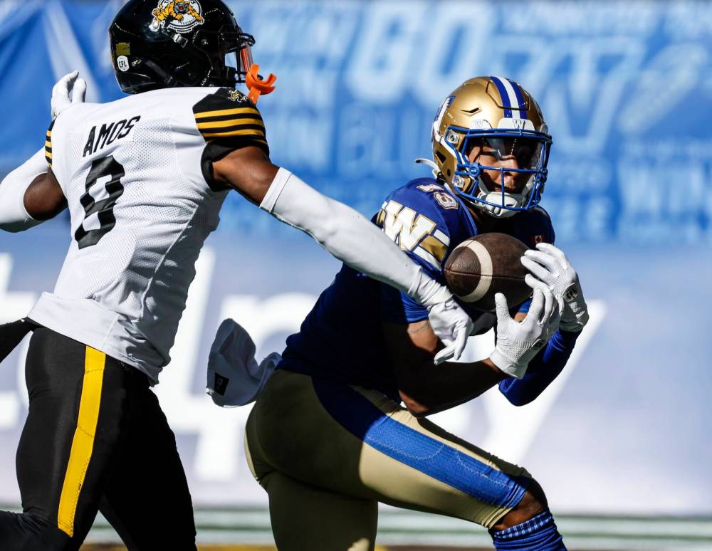 JOHN WOODS / THE CANADIAN PRESS FILES
Blue Bombers receiver Dillon Mitchell pulls down a touchdown pass against the Hamilton Tiger-Cats.