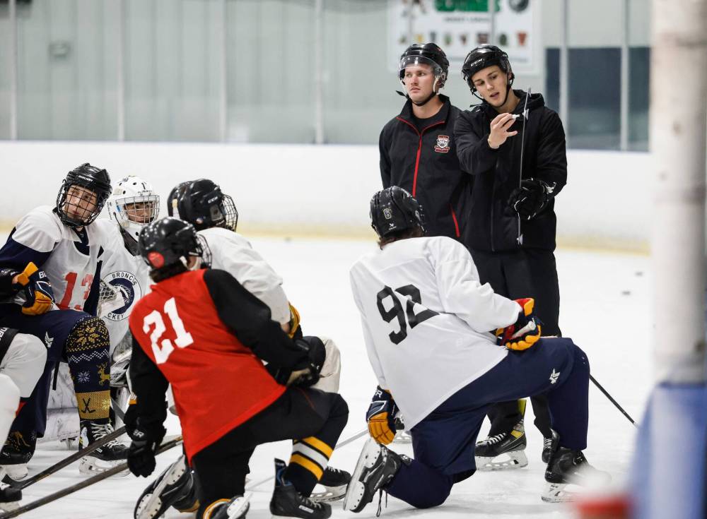 JOHN WOODS / FREE PRESS
JH Bruns teacher/coach Tyler Brown, right, talks to his players during try-outs for the new team.