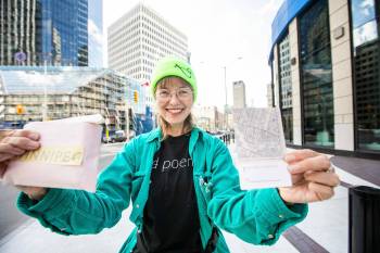 MIKAELA MACKENZIE / FREE PRESS Winnipeg poet laureate Jennifer Still with her new city-wide poetry project, The Story of Winnipeg, at Portage and Main on Thursday, Oct. 9, 2025. The fill-in-the-blank tiny map books, made out of City of Winnipeg archival materials, will be available at library branches for Winnipeggers to fill out. For Jen story. Free Press 2025
                                MIKAELA MACKENZIE PHOTOS / FREE PRESS
                                The fill-in-the-blank tiny map books for Winnipeg poet laureate Jennifer Still’s new citywide poetry project will be available at library branches for Winnipeggers to fill out.