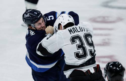 JOHN WOODS / THE CANADIAN PRESS
Winnipeg Jets' Luke Schenn (5) and Los Angeles Kings' Jeff Malott (39) fight during first period NHL action in Winnipeg on Saturday.