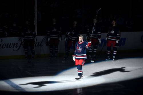 Bryan Little acknowledges the fans prior to the NHL game between the Winnipeg Jets and Pittsburgh Penguins in Winnipeg, Sunday, Oct. 20, 2024. In November 2019, Little suffered a career-ending injury. Little was signed to a one-day contract prior to Sunday’s game so he can officially retire from the NHL as a member of the Jets. THE CANADIAN PRESS/Fred Greenslade