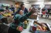 JOHN WOODS / FREE PRESS
                                Pierre Poilievre, Conservative leader, poses for a selfie and talks to volunteer Katya Labelle as he fills food baskets at Agape Table, a local non-profit food bank in Winnipeg Monday, October 13, 2025. Poilievre toured the facility, filled weekly food baskets and met with staff and volunteers. Reporter: eric