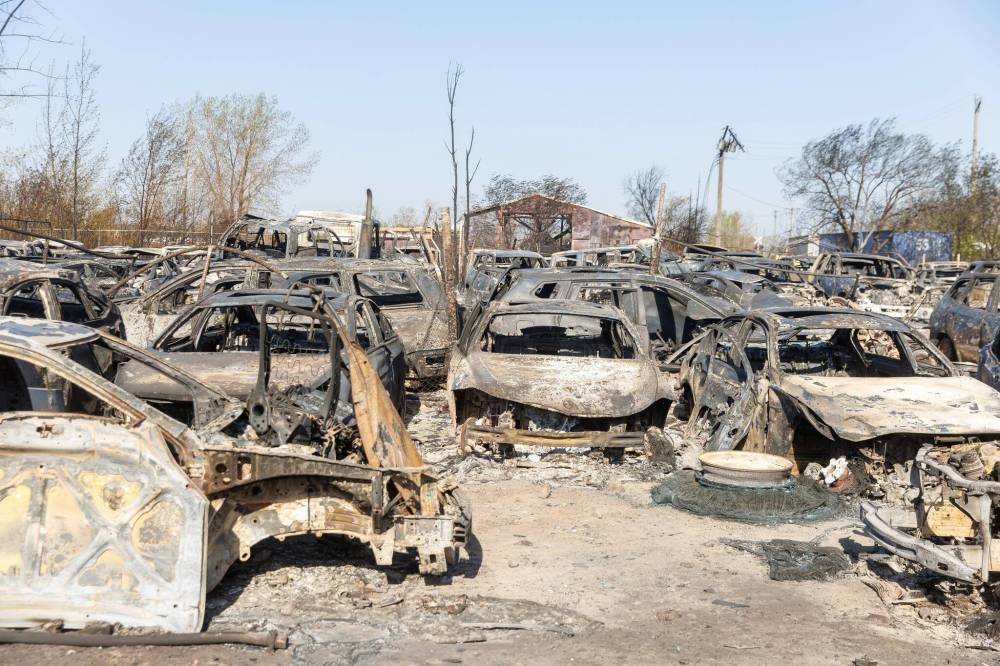 MIKE DEAL / FREE PRESS Hundreds of burnt out cars sit in a lot at 568 Gunn Road, destroyed by a grassfire that ravaged several businesses in North Transcona on Monday. Reporter: Nicole Buffie 250513 - Tuesday, May 13, 2025.