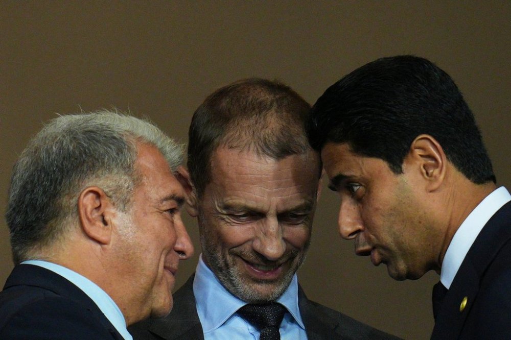 UEFA President Aleksander Ceferin, center, FC Barcelona president Joan Laporta, left, and PSG president Nasser Al-Khelaifi speak before the Champions League opening phase soccer match between Barcelona and Paris Saint-Germain at the Lluis Companys Olympic Stadium in Barcelona, Spain, Wednesday, Oct.1, 2025. (AP Photo/Emilio Morenatti)
