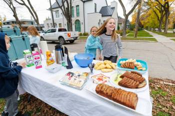 MIKE DEAL / FREE PRESS
                                Annie MacDonald (centre-right) and her friend Ruby Kurz react after serving teachers from their school who came by for morning coffee.