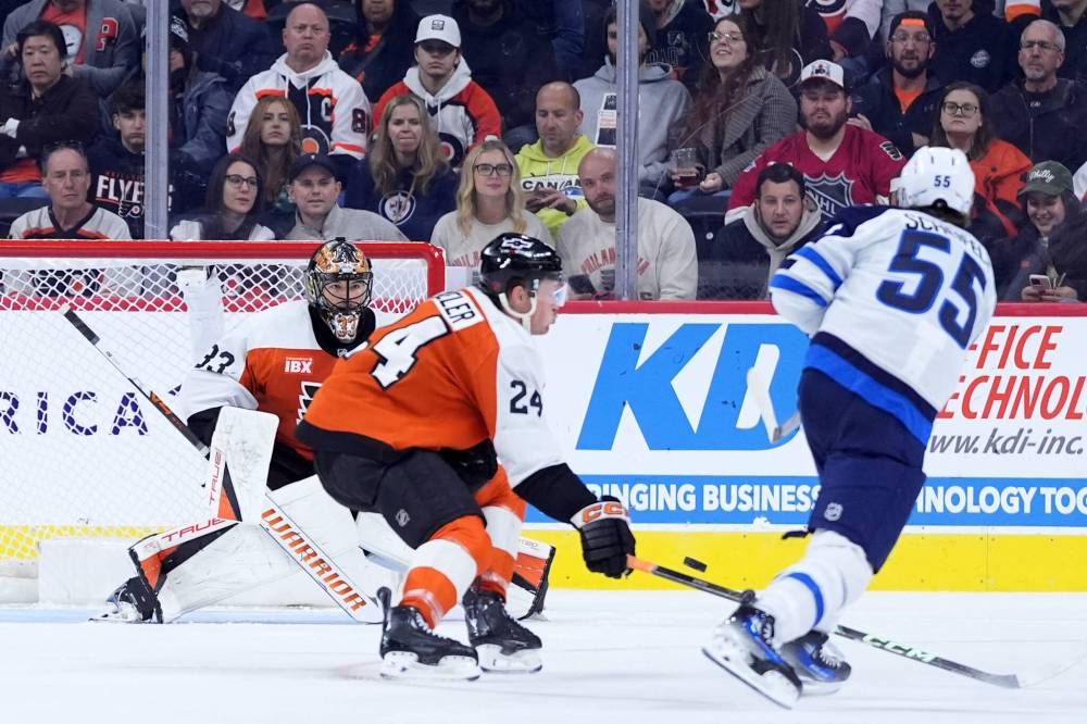 Matt Slocum / The Associated Press
Winnipeg Jets’ Mark Scheifele scores one of his two goal against the Flyers Thursday in Philadelphia.