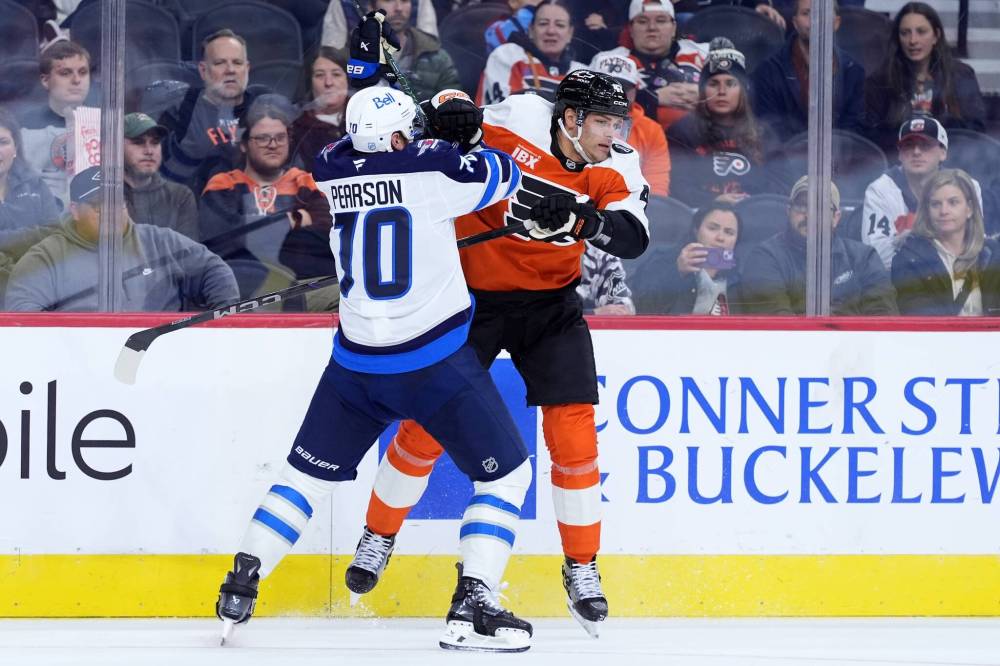 Matt Slocum / The Associated Press
The Jets’ Tanner Pearson (left) and Philadelphia’s Noah Juulsen get to know each other during second-period action.