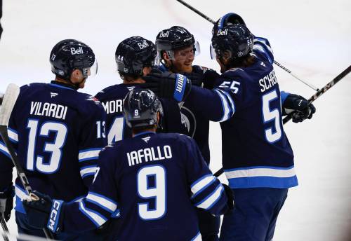 Winnipeg Jets' Gabriel Vilardi (13), Josh Morrissey (44), Alex Iafallo (9), Kyle Connor (81) celebrate Mark Scheifele's (55) goal against the Nashville Predators during first period NHL action in Winnipeg on Saturday, October 18, 2025. THE CANADIAN PRESS/John Woods