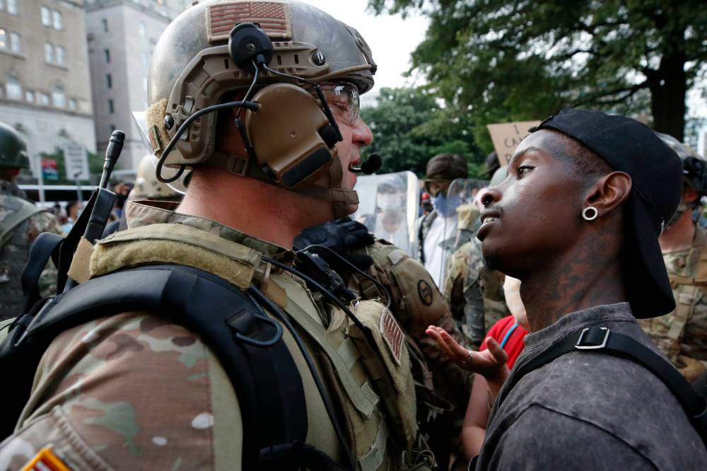 Alex Brandon / Associated Press files
                                In this June 2020 photo, a demonstrator stares down a National Guard soldier at a protest near the White House in Washington,, D.C. over the death of George Floyd in Minneapolis after he was restrained by police officers.